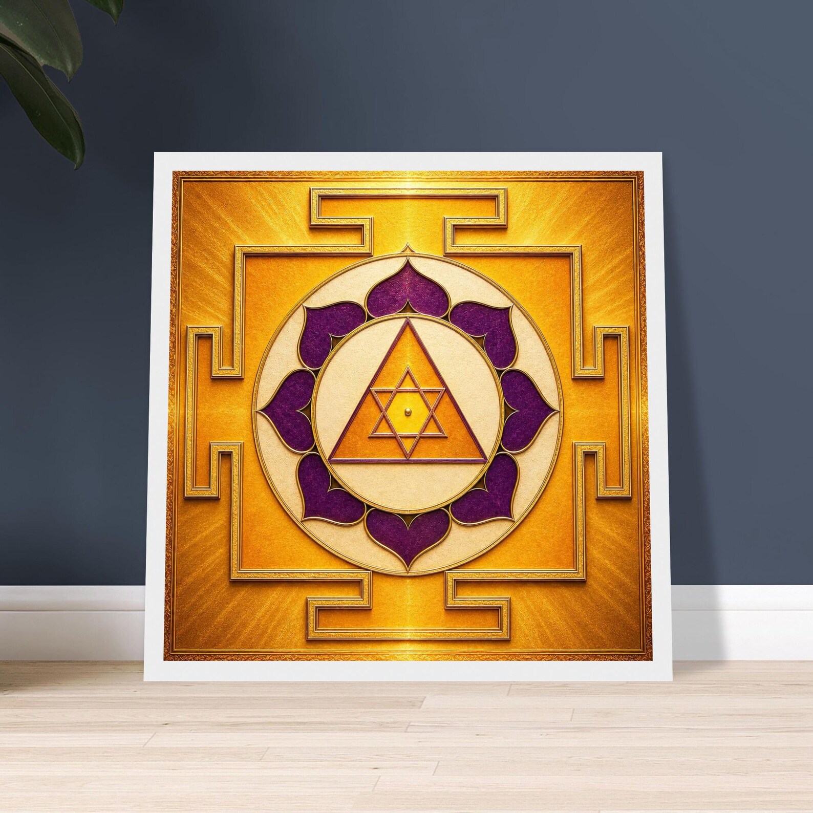 Square Ganesh Yantra poster print in gold and purple leaning against a dark wall